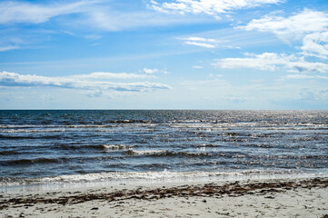 Vacation in Sweden - Vacation on the sandy beach Mossbystrand beach with a view of the Baltic Sea, in summer with a blue sky, Skivarp, Öresund, Skane Lan, Sweden