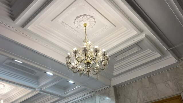 Brass large luxury precious cry stal gold tired chandels. A large bright chandelier with white stones, a rare lamp, a precious chandelier. Classik Glass Chandelier. High quality 4k footage