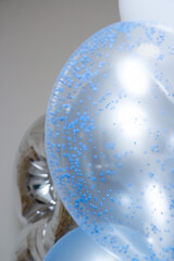 silver and blue balloons on a white background, happy birthday greeting