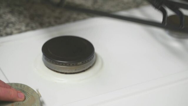 Mature hands cleaning kitchen stove
