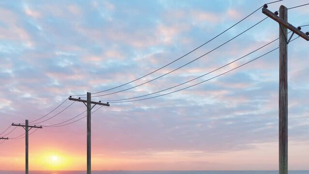 A close-up view of multiple electricity poles and cables at sunset.