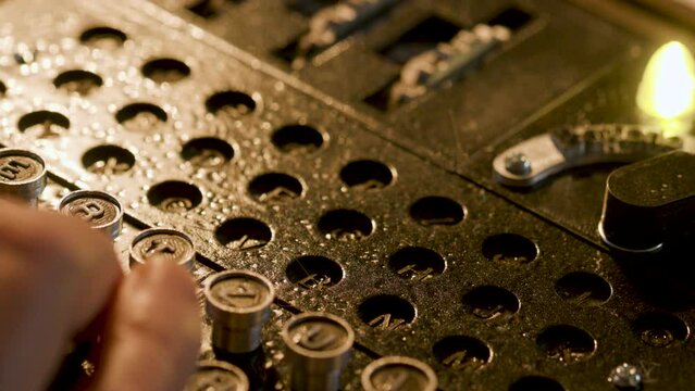 overhead shot of a man using a WWII enigma code machine