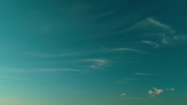 Unusual cirrus clouds in blue sky. Wide angle contrast daytime nature background.