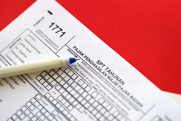 Indonesian tax form 1771 corporate taxpayers annual income tax return with pen lies on accountant...