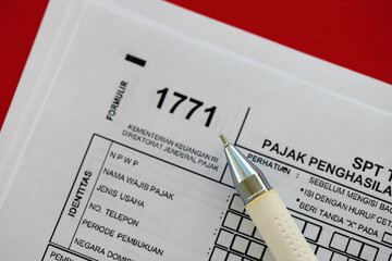 Indonesian tax form 1771 corporate taxpayers annual income tax return with pen lies on accountant...