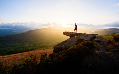 Silhouette of a person on Bamford Edge, Peak District UK