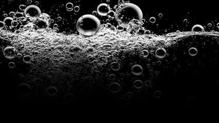 Soda water bubbles splashing underwater against black background. Soda liquid texture that fizzing...