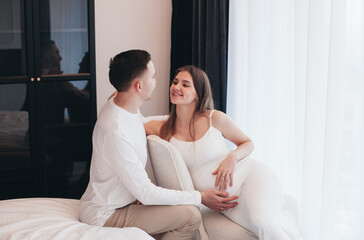 young expectant mother and father at home