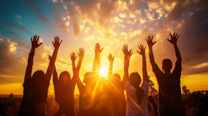 Silhouettes of a Crowd with Hands Raised Toward a Glowing Sunset Sky