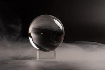 crystal ball, beautiful crystal ball with smoke on black background, selective focus.