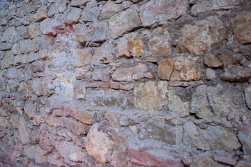 Stone wall with old bricks of the acient castle. Gray brick surface.