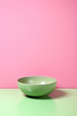 Sleek Green Plate on Pink Surface. side view