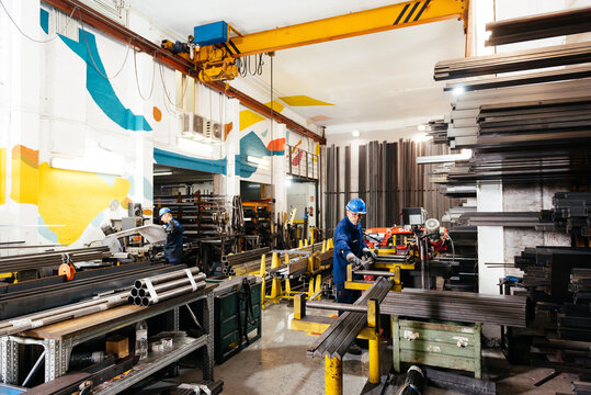 Factory workers working in industrial workshop during construction