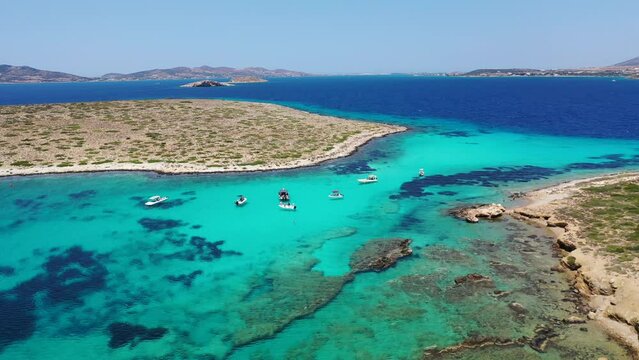 Aerial drone video of azure paradise blue lagoon of Panteronisi a small islet complex between Paros and Antiparos islands, Cyclades, Greece