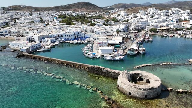Aerial drone video from picturesque small seaside village of Naoussa with traditional Cycladic character, Paros island, Cyclades, Greece