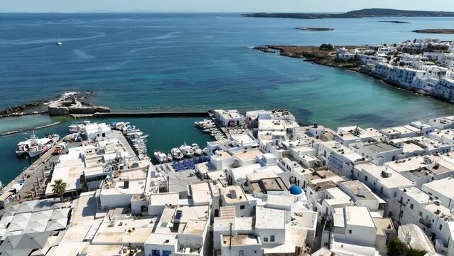 Aerial drone video from picturesque small seaside village of Naoussa with traditional Cycladic character, Paros island, Cyclades, Greece