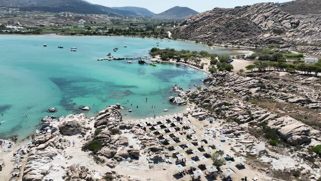 Aerial drone video famous small organised beach with unique rock formations of Kolimbithres or Kolympithres in the gulf of Naousa, Paros island, Cyclades, Greece