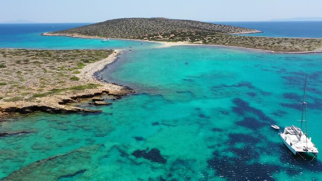 Aerial drone video of azure paradise blue lagoon of Panteronisi a small islet complex between Paros and Antiparos islands, Cyclades, Greece