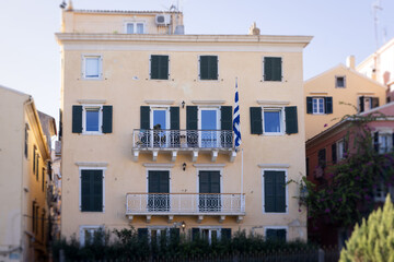 Fototapeta premium Corfu street view, Kerkyra old town beautiful cityscape, Ionian sea Islands, Greece, a summer sunny day, pedestrian streets with shops and cafes, architecture of historic center, travel to Greece