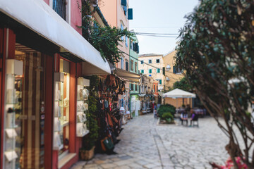 Naklejka premium Corfu street view, Kerkyra old town beautiful cityscape, Ionian sea Islands, Greece, a summer sunny day, pedestrian streets with shops and cafes, architecture of historic center, travel to Greece