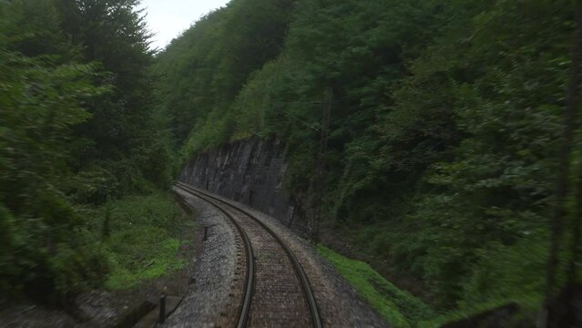 POV view train vintage track with tunnels in mountain forest