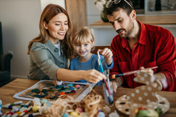 Joyful family gathers around the table for holiday crafting