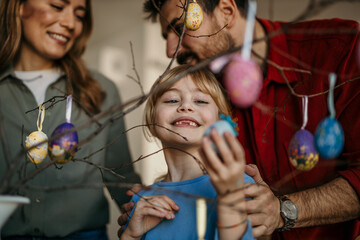 Mom, dad, and daughter happily attend an Easter Sunday brunch