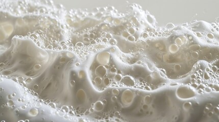  a close up of a white substance on a white surface with a lot of water droplets on the bottom of the image and a lot of bubbles on the bottom of the image.