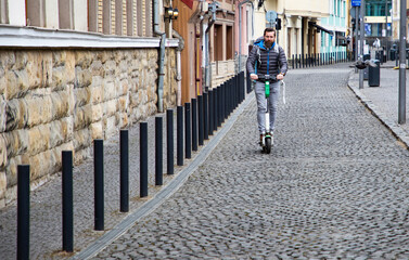 Fototapeta na wymiar man riding electric roller in the city