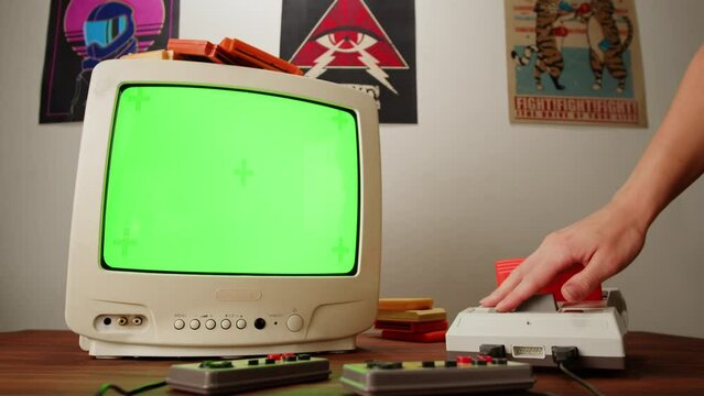 Vintage tv chroma key green screen with Old TV Game Console with ROM Cartridge with TV, Vintage Gamer Room Joystick and Retro TV, Man Player Start the Game, Play.
