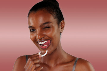 Smiling African American Woman Using Dental Floss