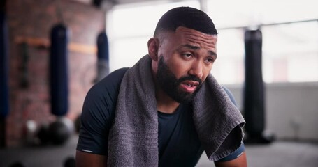 Gym, towel and tired man with fitness break, breathing or recovery from intense performance. Sport, burnout and face of male athlete sweating from physical challenge, workout or training fatigue