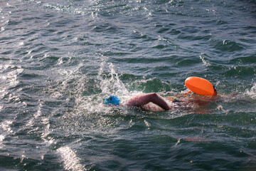 A swimmer in open water, open water swimming, winter swimming, swimming competition, swimming race