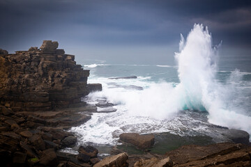 waves crashing on the rocky coast of the Atlantic ocean next to Cruz dos Remedios, Peniche,...