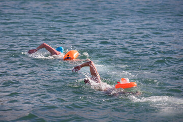 swimmers racing in competition, swimmers in open water, open water swimming 