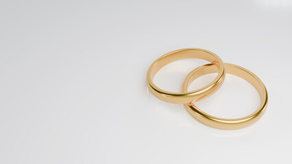 Two golden wedding rings on white background with copy space. 3D rendering.