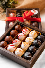 Pop tarts of various flavours (red velvet, cookie, Speculoos and chocolate) arranged in a golden box with a red tie as a present
