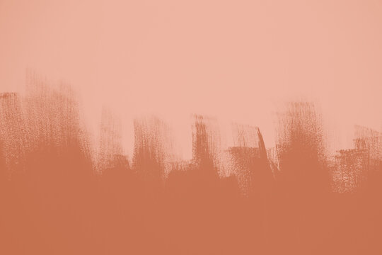 Photo of paint with a dynamic brushstroke texture and contrast between light and dark shades. Backdrop for graphic resource or decorative copy space on websites. peach, coral, pink, terracotta