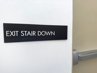 Stair down sign on a white wall