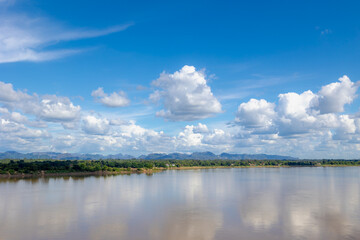 Landscape view of Laos along Mekong river, Big mountain, small villages and forest, Riverside between Thai and Laos border with blue sky, Nakhon Phanom province, Northeastern Thailand also called Isan