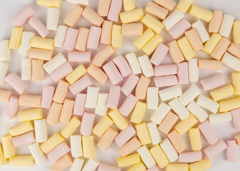 Pink yellow and white marshmallow background. The concept of colored marshmallows.