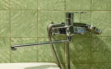Dirty tap, in an old bathroom, limescale on the faucet. Concepts of dirty drinking water and water consumption.