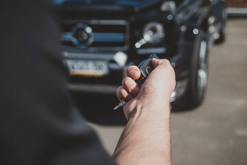 Hand with car keys on a sunny day