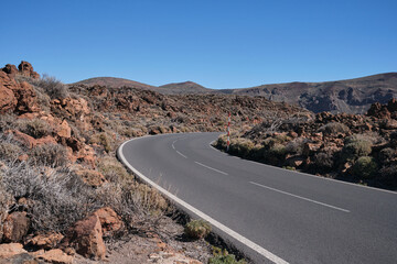 Road to mount El Teide National Park, Tenerife, Canary Islands, Spain. Volcanic dry landscape. Road with volcanic scenery.