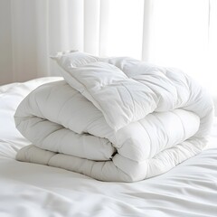 Fototapeta na wymiar White folded duvet on a bed, symbolizing winter season readiness and cozy home decor.