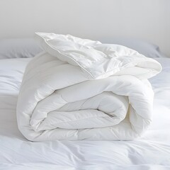 White folded duvet on a bed, symbolizing winter season readiness and cozy home decor.