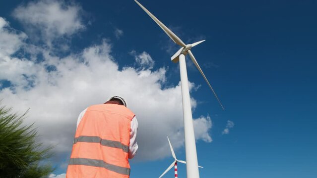 Architect is verifying the suitability of the wind turbines by drone
