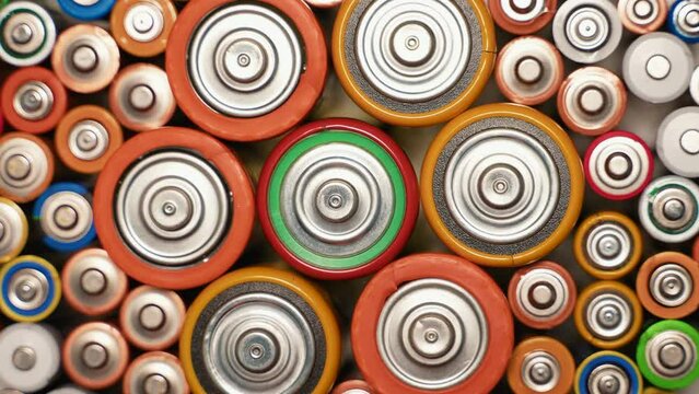 Old used batteries type AA, AAA, D rotate in a circle