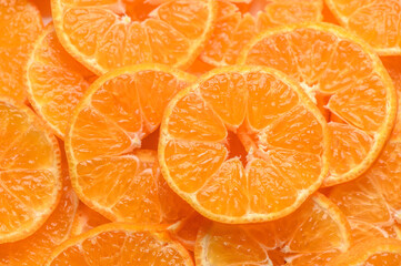 sliced ​​juicy appetizing tangerines as a food background 3