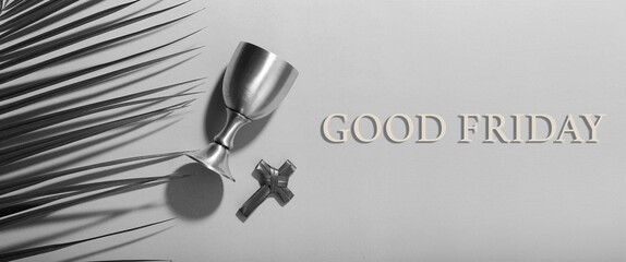 Cross, palm leaves and wine cup on light background. Good Friday